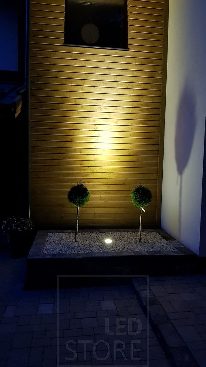 LED LAND LIGHT embedded in the ground and illuminated at dusk